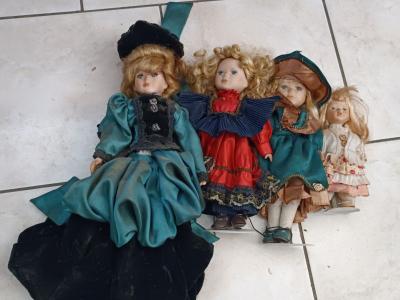 Lot 4 poup�es porcelaine 45 cm sur socles, habill�es (vert-noir, rouge-bleu)