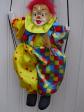 Poup�e clown en porcelaine sur une balan�oire.